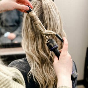 stylist curling hair