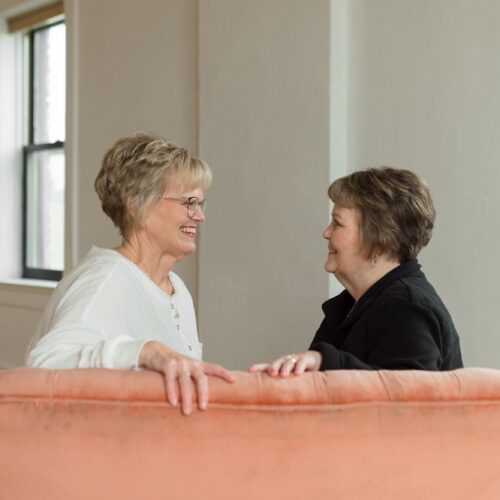 women smiling on couch