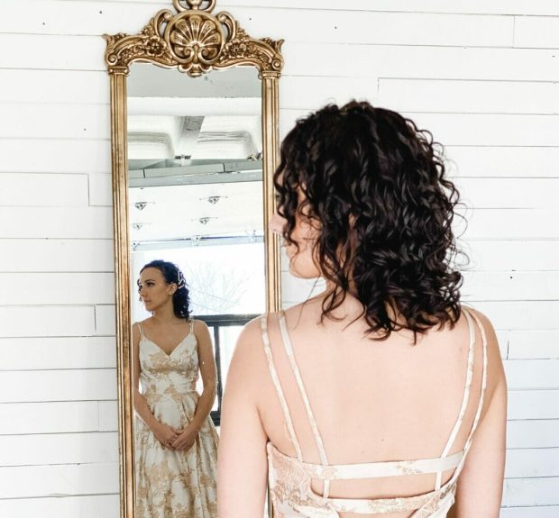 girl in mirror reflection with curled hair